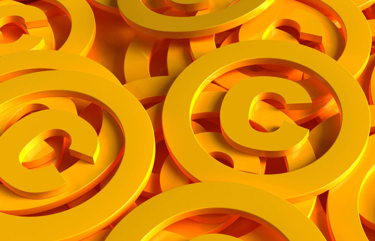 Abstract pattern of overlapping yellow copyright symbols on an orange background.