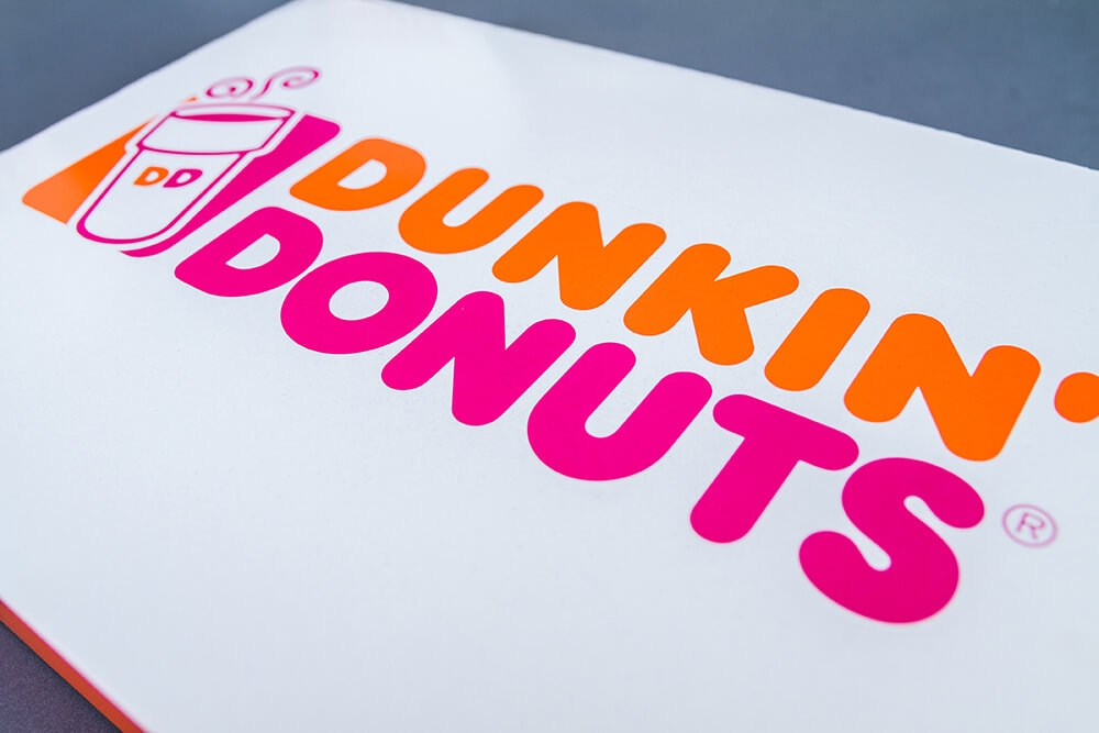 Original Dunkin' Donuts logo with the full brand name and coffee cup icon, illustrating the company's identity before its 2018 rebrand to simply "Dunkin'."